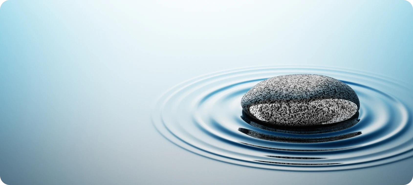Zen stone creating water ripples