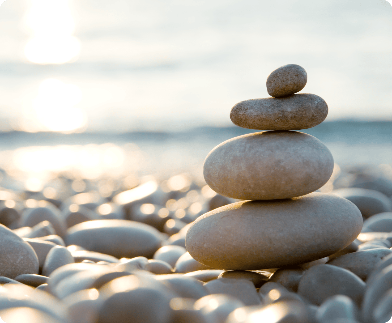 Pebbles stacked by the sea